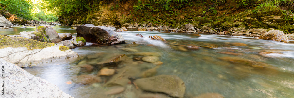 Mountain river in forest. Water on a stones