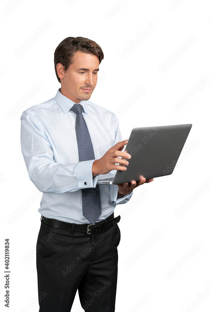 Businessman in blue shirt and tie standing with laptop in hands, isolated over white background. Caucasian manager smiling, looking at the laptop screen