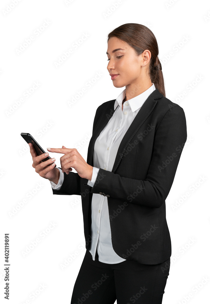 Businesswoman in black suit standing using the phone, isolated over white background. Young female office manager looking at the phone Businesswoman in black suit standing using the phone, isolated over white background. Young female office manager looking at the phone