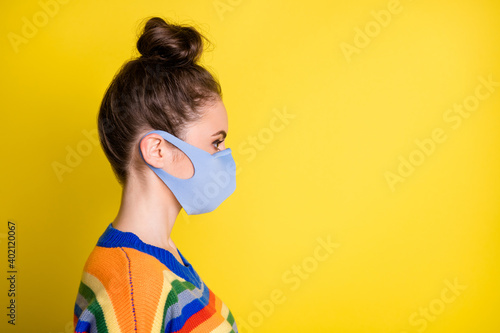 Profile side photo of pretty lady social distance wear mask look empty space isolated on shine yellow color background © deagreez