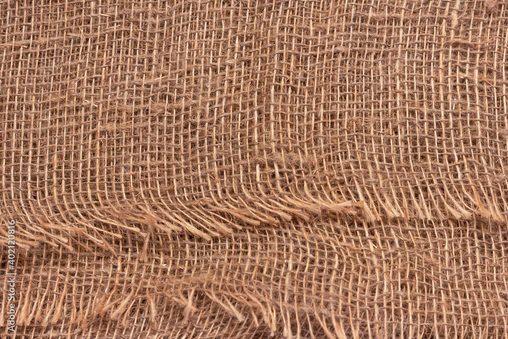 The texture of an uneven crumpled, roughly woven burlap. The texture of an uneven crumpled, roughly woven burlap.