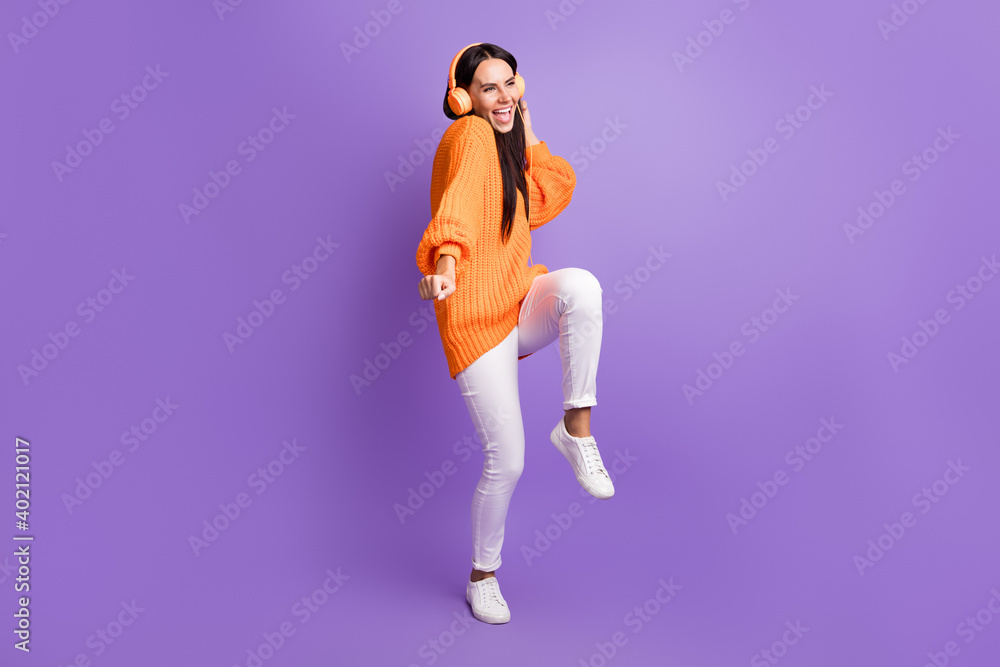 Full size photo of optimistic funky girl dance listen song wear red sweater trousers sneakers isolated on lilac background