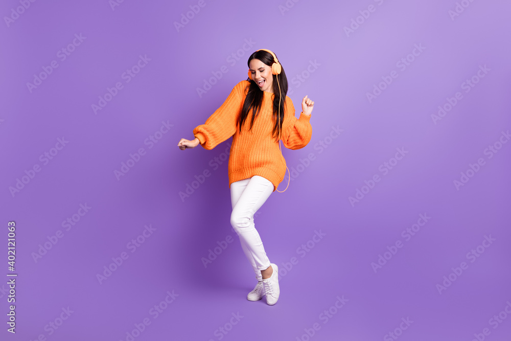 Full size photo of optimistic nice girl dance listen music wear red sweater trousers sneakers isolated on lilac background