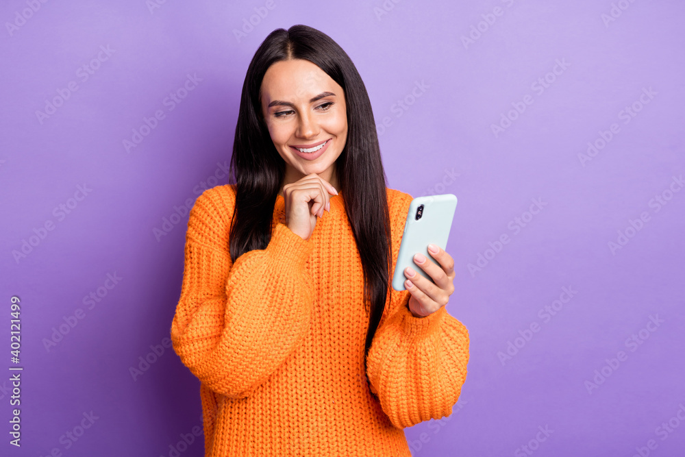 Photo of attractive positive lady arm on chin look interested screen isolated on violet color background Photo of attractive positive lady arm on chin look interested screen isolated on violet color background