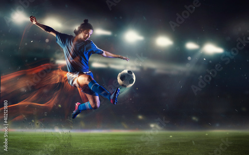 Fototapeta Naklejka Na Ścianę i Meble -  Speed. Young male soccer or football player kicking ball during match at the stadium in flashlights, spotlights. Concept of professional sport, motion, movement. 3D render. Flyer for ad.