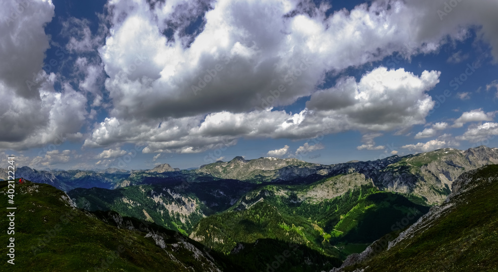 wonderful mountains with large white clouds on the blue sky panorama