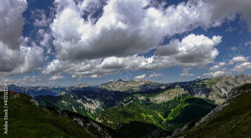 wonderful mountains with large white clouds on the blue sky panorama