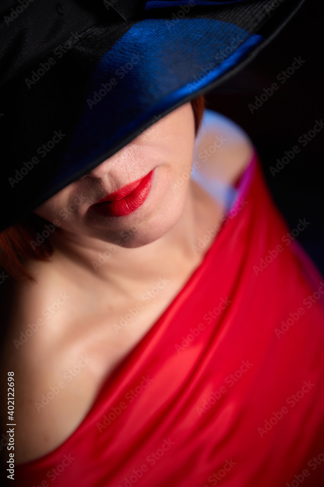 Portrait of ugle middle-aged woman with hat and red dress. Ugly model looking as lady posing in studio. Portrait of ugle middle-aged woman with hat and red dress. Ugly model looking as lady posing in studio.