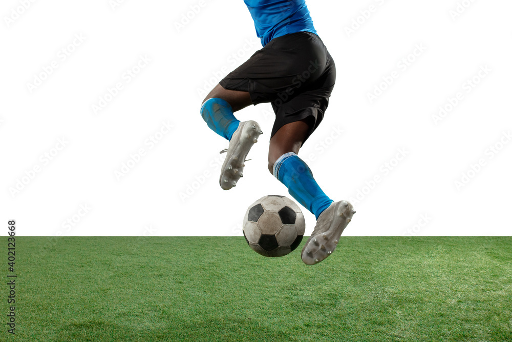 Close up legs of professional soccer, football player fighting for ball on field isolated on white background. Concept of action, motion, high tensioned emotion during game. Cropped image.