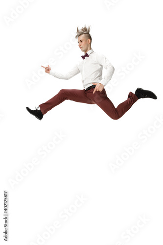 Rockstar. Happy young man dancing in casual clothes or suit, remaking legendary moves and dances of celebrity from culture history. Isolated on white. Action, motion, fame concept. Creative occupation