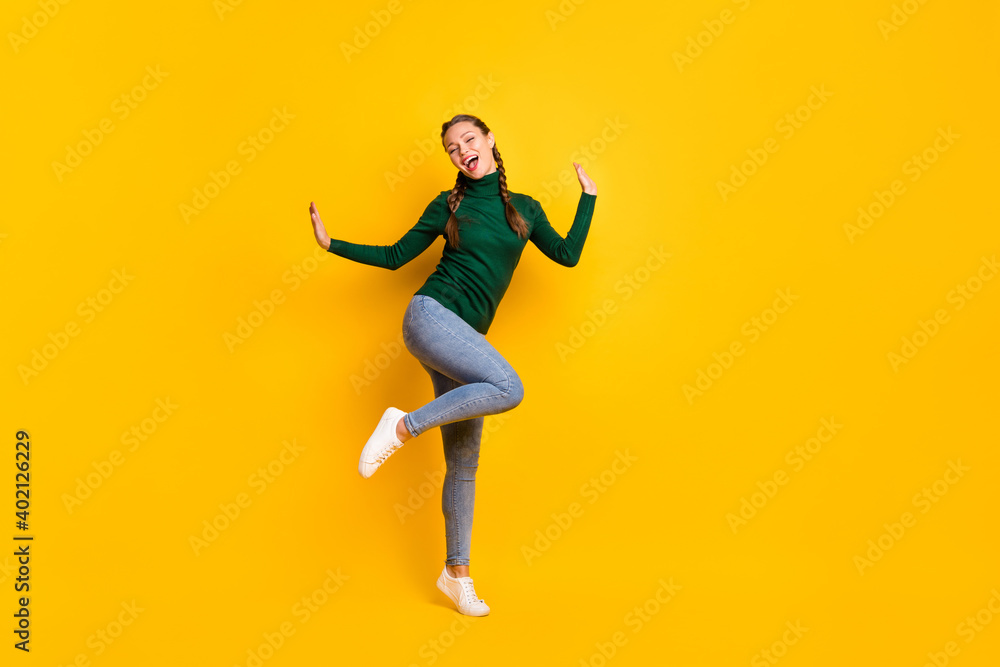 Full length body size photo female student laughing dancing at party isolated on vivid yellow color background