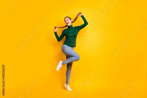 Full length body size photo female student laughing dancing cheerful enjoying isolated on vibrant yellow color background