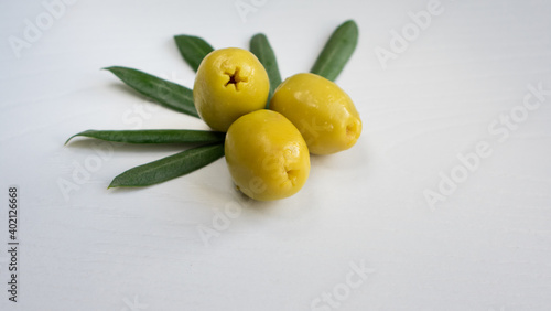 Green olives close up on a white background.