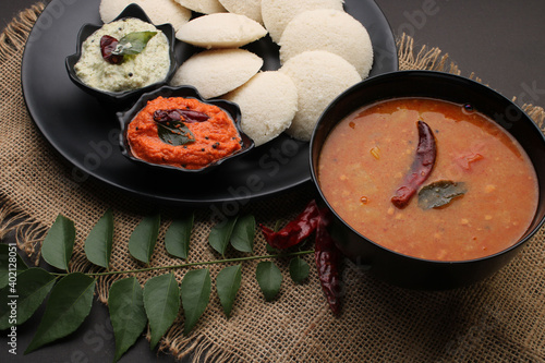 Idly sambar or Idli with Sambhar and green, red chutney. Popular South indian breakfast photo