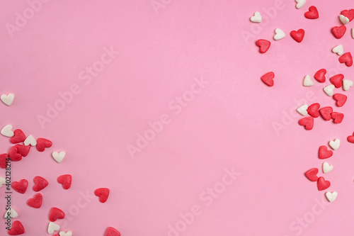 Fotografía Sugar heart shaped sprinkles on pastel pink background