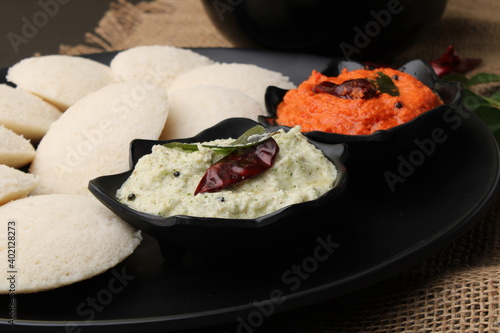 Idly sambar or Idli with Sambhar and green, red chutney. Popular South indian breakfast photo