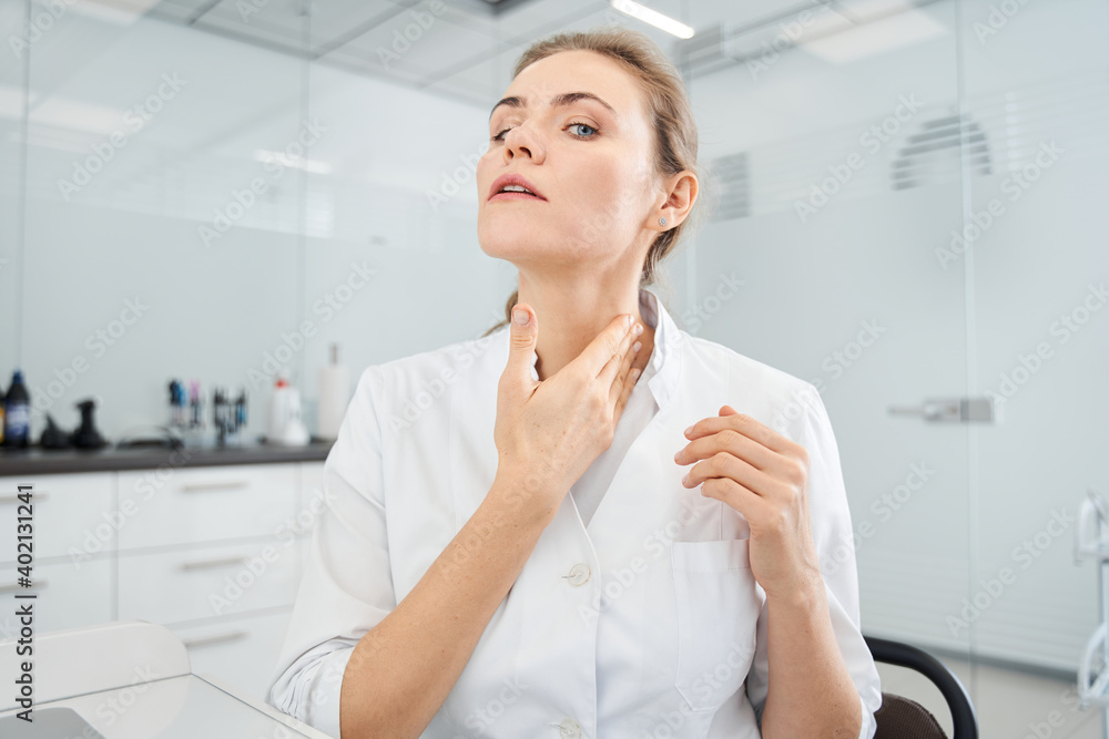 Skilful blonde female dentist providing video call with patients Skilful blonde female dentist providing video call with patients