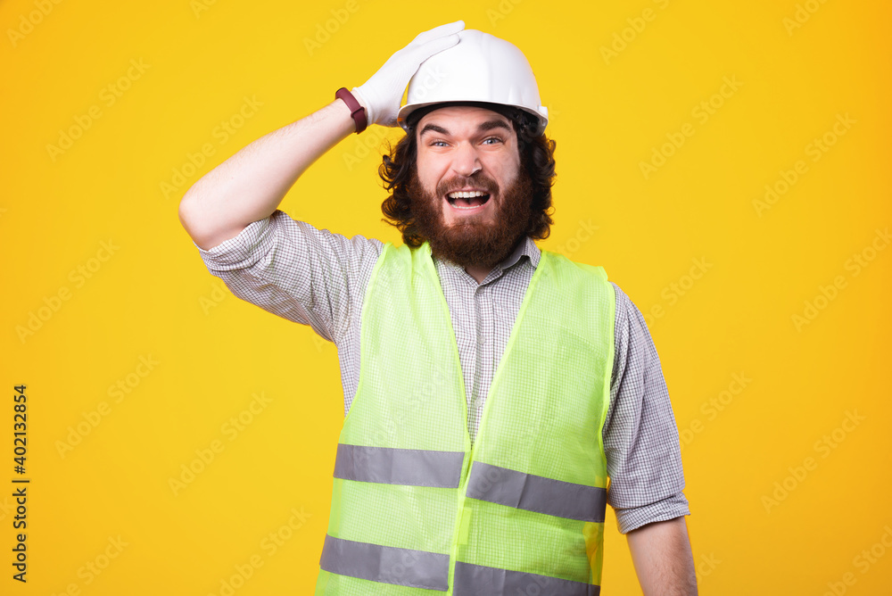 Engineer forgot something to do, face expression of constructor wearing helmet.