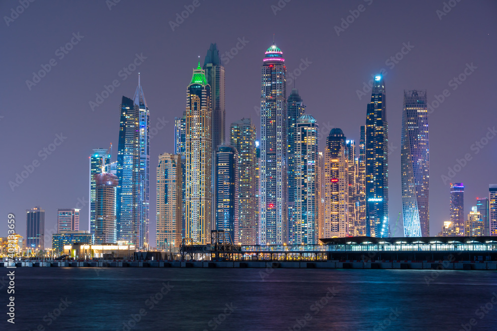 Night view to Dubai panorama. Amazing illumination of the modern iconic skyscrapers at twilights. Shot at blue hour.