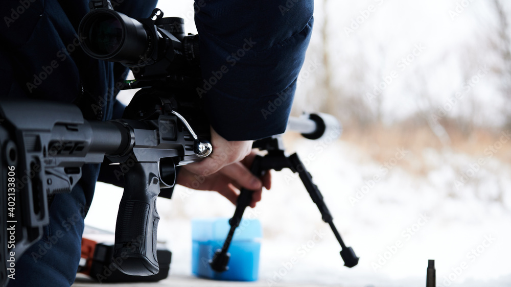 A man takes a sniper rifle before shooting sports. Bolt rifle of Russian or Soviet production. Lancaster A man takes a sniper rifle before shooting sports. Bolt rifle of Russian or Soviet production. Lancaster