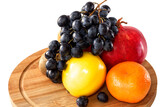 Fresh juicy bright fruits for a healthy diet on a kitchen wooden board.
