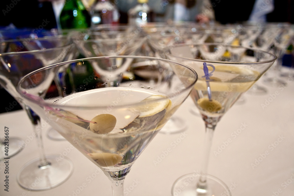 Martini cocktails served on a bar table during fancy evening event party. Martini cocktails served on a bar table during fancy evening event party.