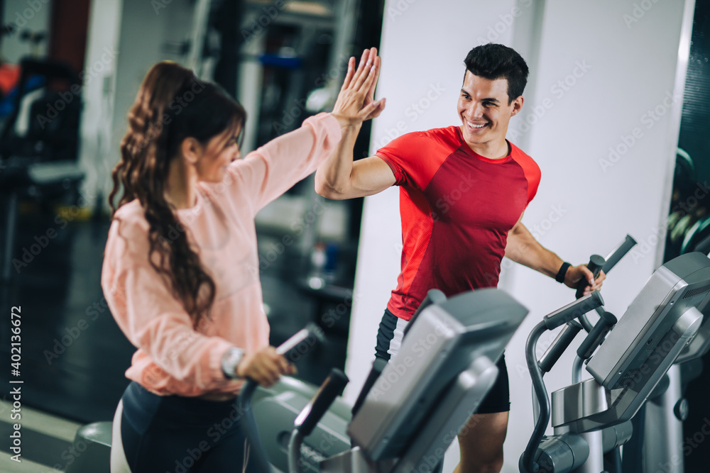 Fitness instructor with girl on training in fitness center Fitness instructor with girl on training in fitness center