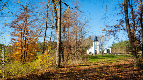 Small chapel in the forest at autumn