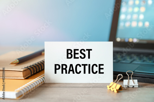 Best Practice - an inscription on a card near office supplies