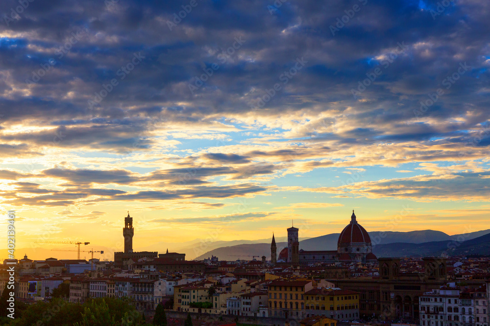Palazzo Vecchino and the Florence Cathedral in the Piazza del Duomo, seen from Piazzale Michelangelo, Florence, Tuscany, Italy are silhouetted during a sunset. 