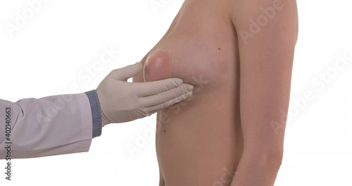 Side view of a mammologist doctor is checking woman breast. Isolated, white background. Healthcare concept.
