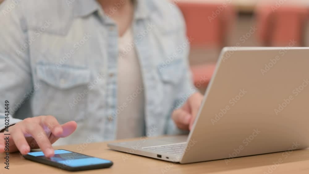 Male Hands using Smartphone and Typing on Laptop, Close up Male Hands using Smartphone and Typing on Laptop, Close up