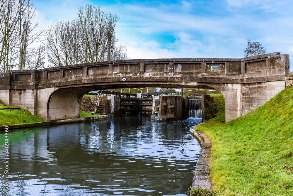 Fototapeta premium A view under bridge 54 of lock gates at Hatton Locks towards Warwick, UK on a winters day