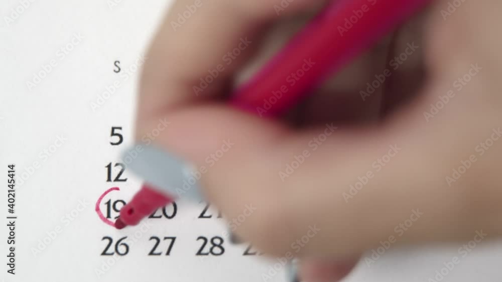 Female hand circle day in calendar date with a red marker. Business Basics Wall Calendar Planner and Organizer. APRIL 19th Female hand circle day in calendar date with a red marker. Business Basics Wall Calendar Planner and Organizer. APRIL 19th