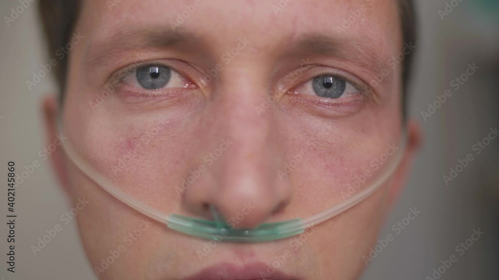 oxygen therapy, coronavirus pandemic. breathing with oxygen tubing