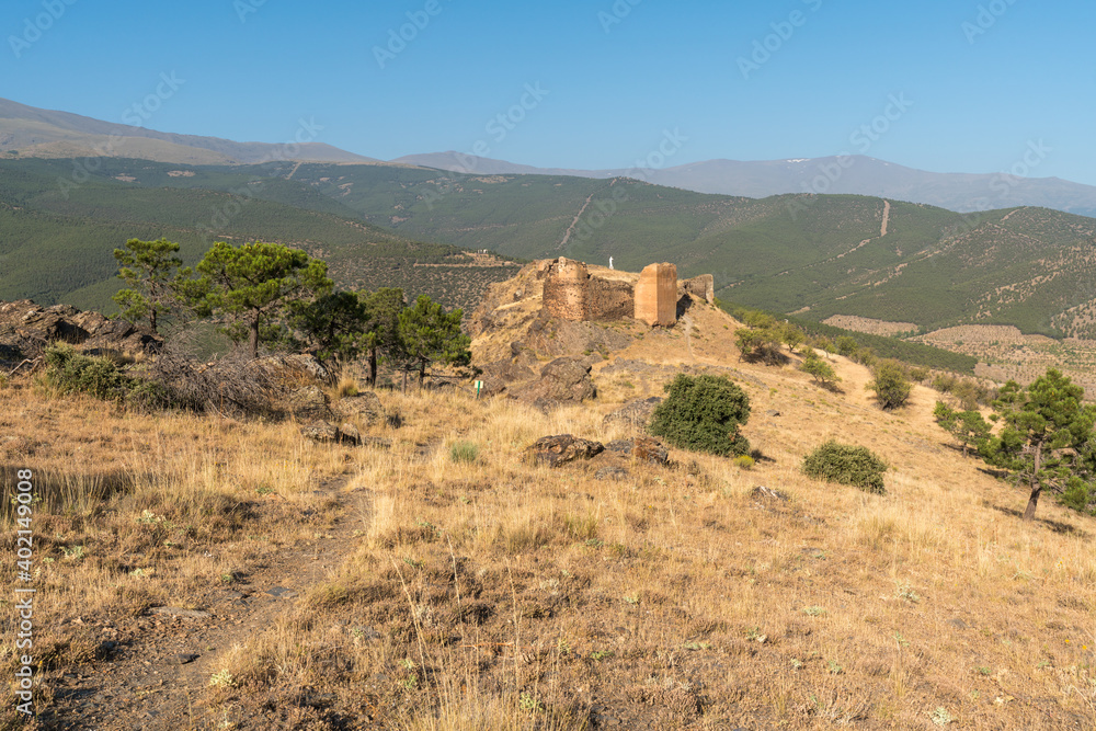 Fototapeta premium Ruins of an old castle on top of a mountain