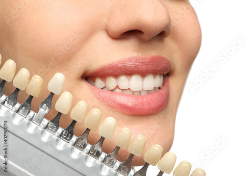 Woman checking her teeth color on white background  closeup. Cosmetic dentistry