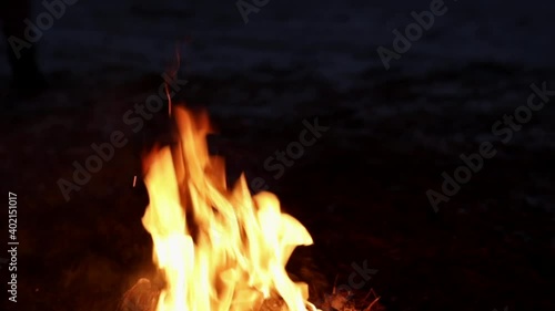 A bonfire with sparks burning in the forest at night