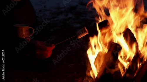 couple in the woods on the fire roast marshmallows
