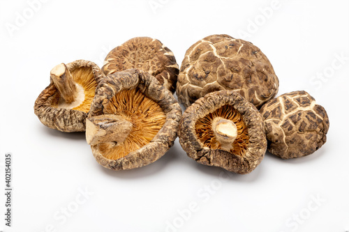 A pile of dried shiitake mushrooms on white isolated background