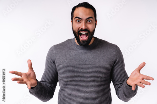 Close up photo of overexcited young Arab man in casual clothes isolated over white background photo