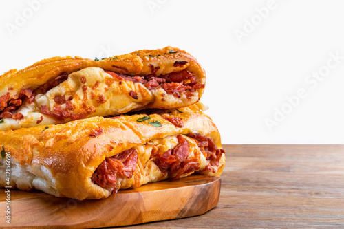 Snacks of pepperoni typical of Brazil, rolled of pepperoni and Italian focaccia. Selective focus. Space for text. White background.