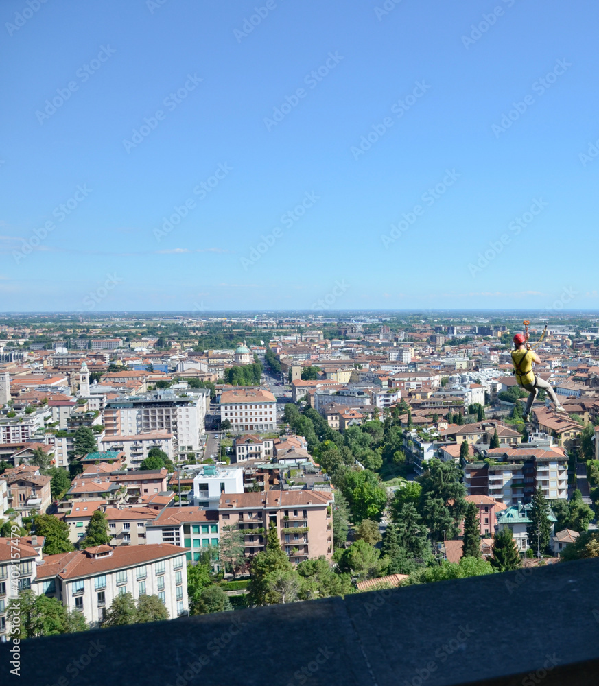 View from the city wall of Bergamo Upper Town towards the Lower Town, a person on a zip wire drive, summer