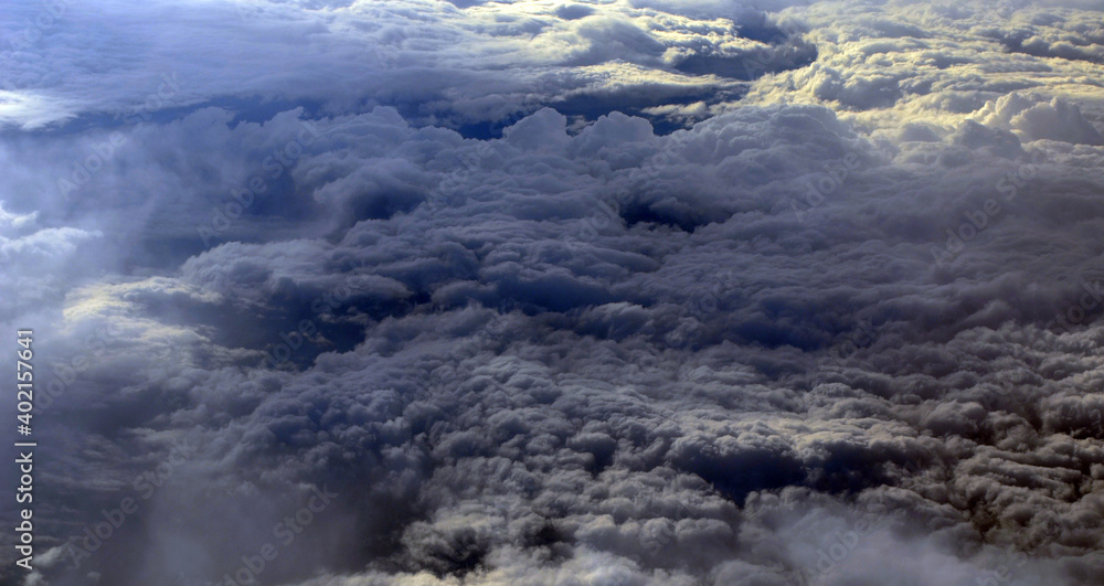 Fototapeta premium Aerial view of clouds and sky. Bird eye view from airplane window. Clouds panorama from airplane. Flight from Kiev to Sharm El Sheikh, Egypt