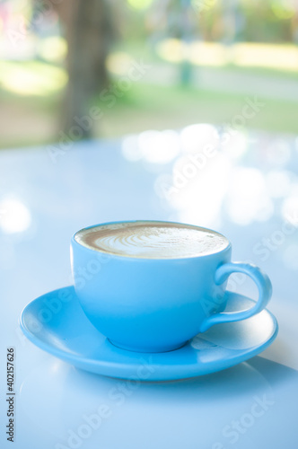 Blue coffe cup on white table with natural background