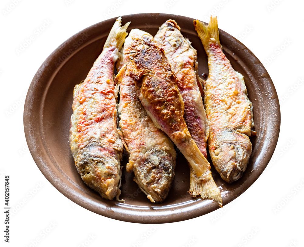 fried red mullet fishes on brown ceramic plate cut out on white background
