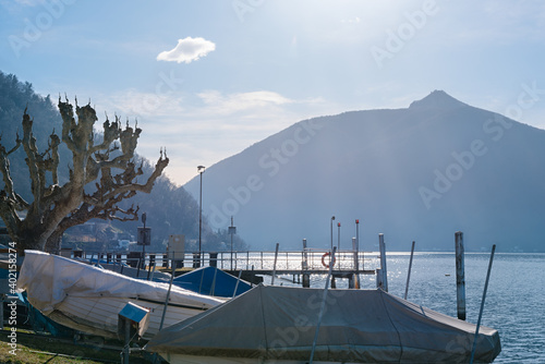 Pier of the Lake Ceresio of village Bissone near Lugano on a sunny day. Canton Ticino. Switzerland photo