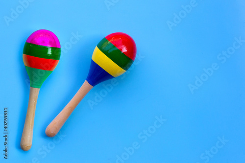 Photography Two maracas on blue background.