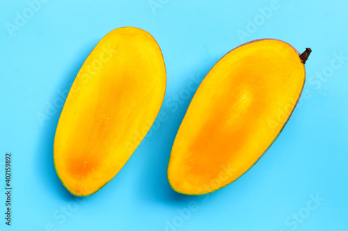 Mango on blue background. Tropical sweet fruit concept.
