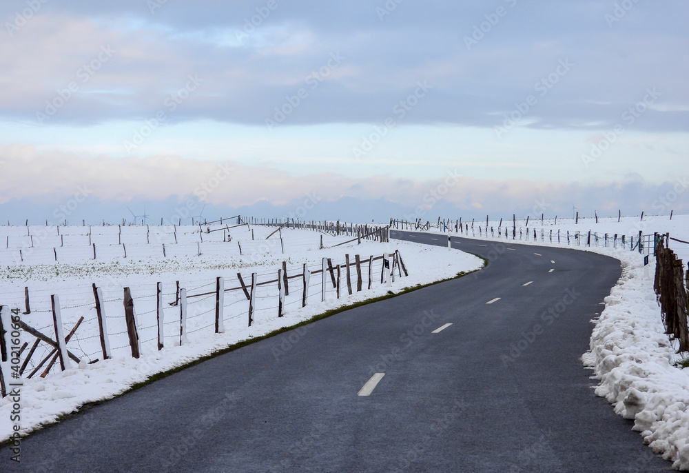 winter landscape with snow, road and fence